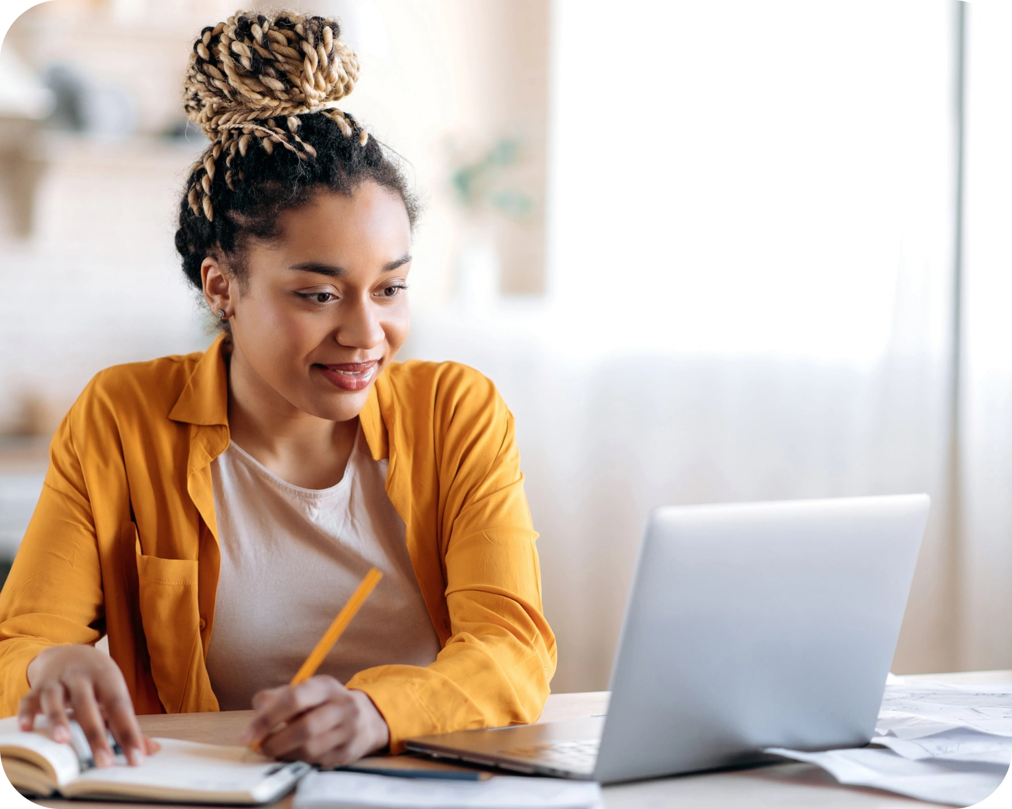 A woman sitting at a table with a laptop.