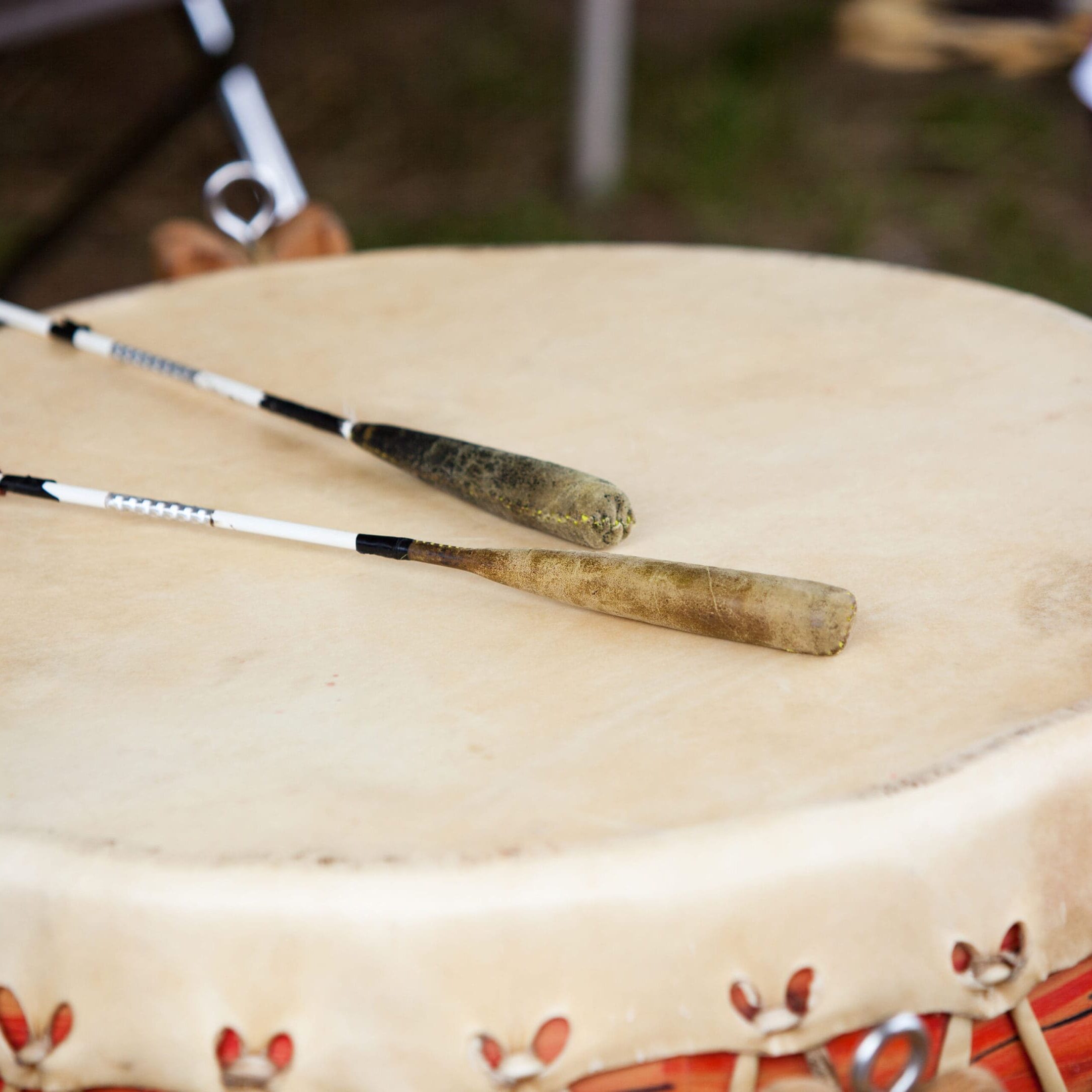 Two brushes are on top of a drum.